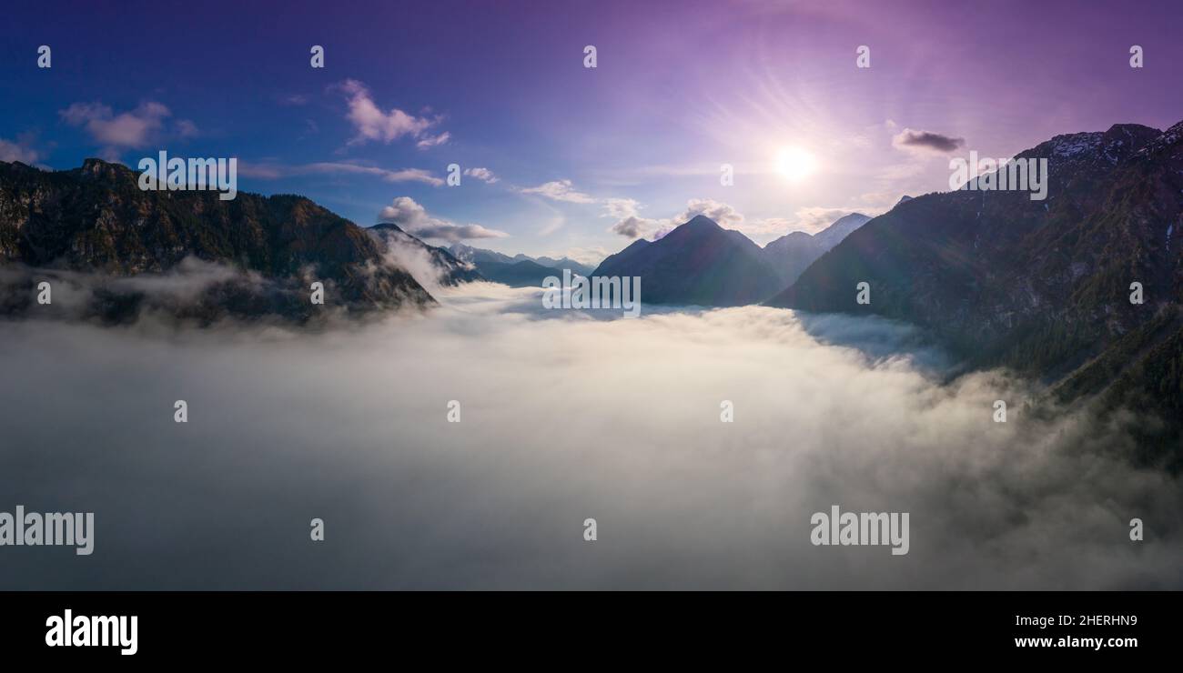 above cloud carpet between tirol mountains at lake plansee while sunrise in spring Stock Photo