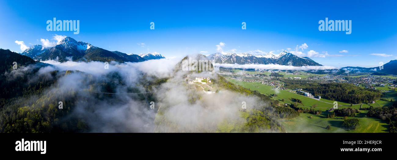 panorama of ruin ehrenberg mountain thaneller with view to village ehenbichl, reutte, hoefen on morning fog Stock Photo