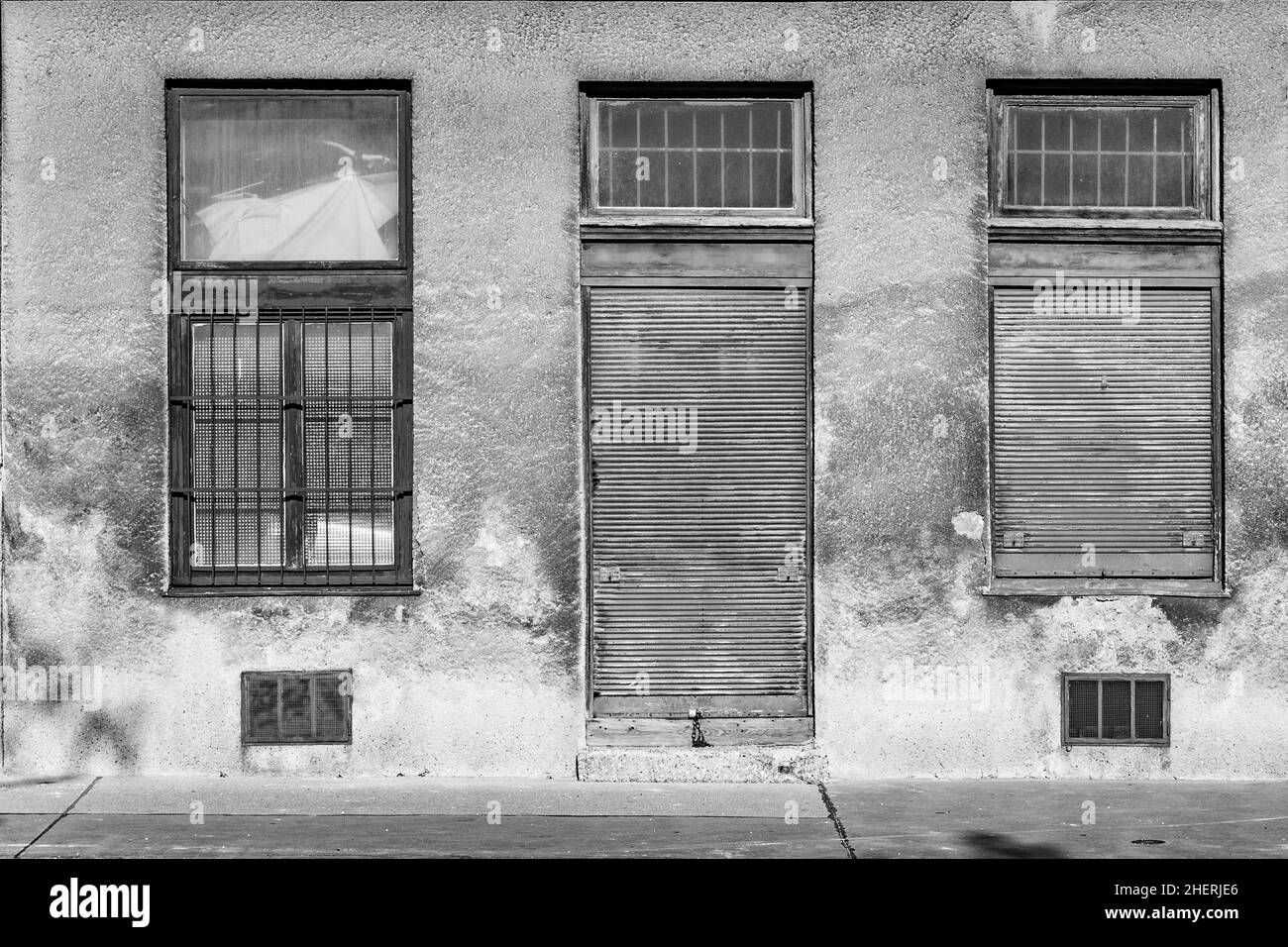 closed door with closed windows at a dirty house facade in Vienna Stock Photo