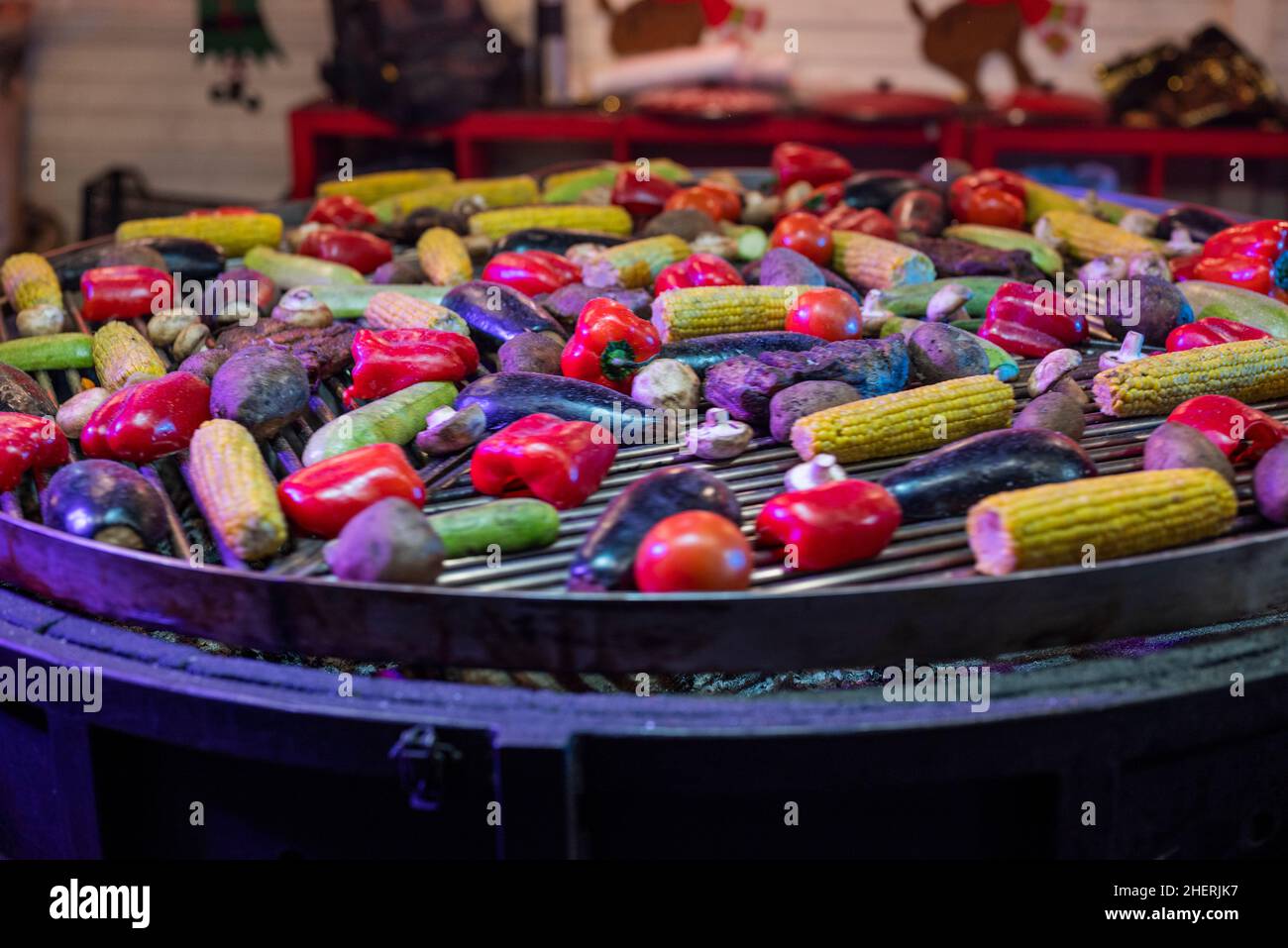 vegetables paprika with corn are prepared in a cauldron at the fair. street food fast food at