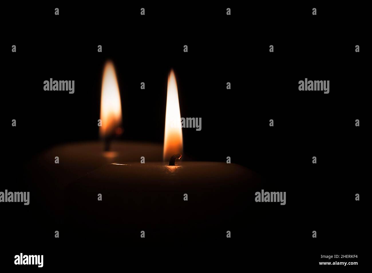 Two flames, candles burning in the darkness, symbol of hope Stock Photo ...
