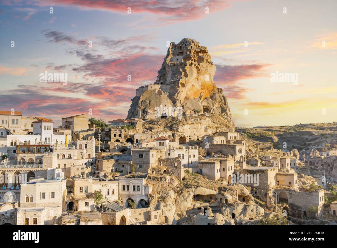 Ortahisar castle or central castle and fairy chimneys in Cappadocia, Turkey. Ortahisar Castle and traditional houses carved stone. Cave houses. Stock Photo