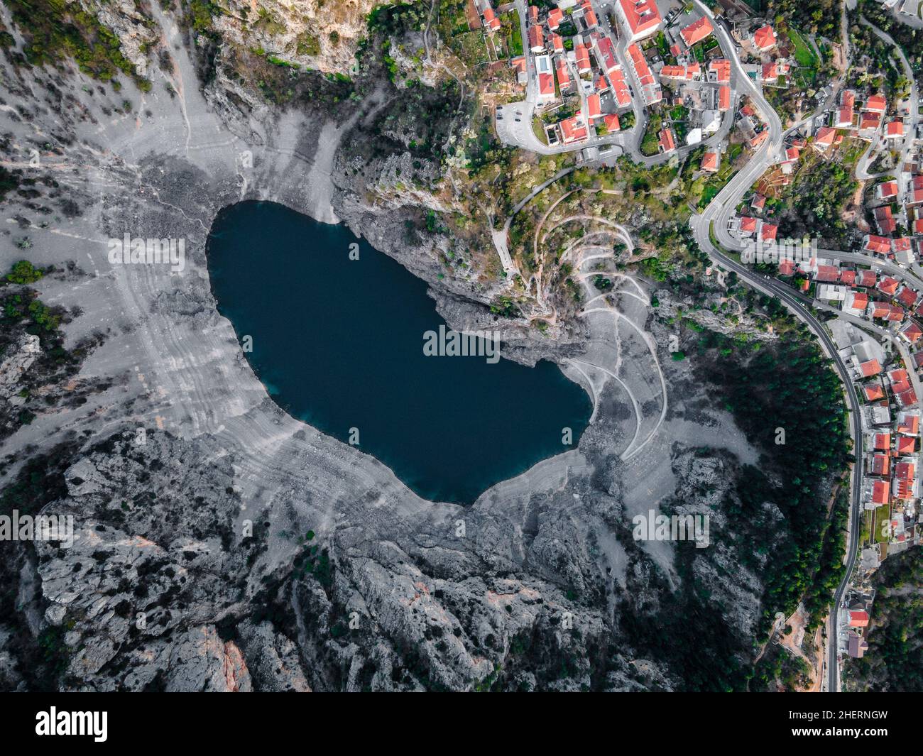 Aerial drone picture of massive crater, blue lake (Modro Jezero) in April at Imotski, Dalmatia, Croatia Stock Photo