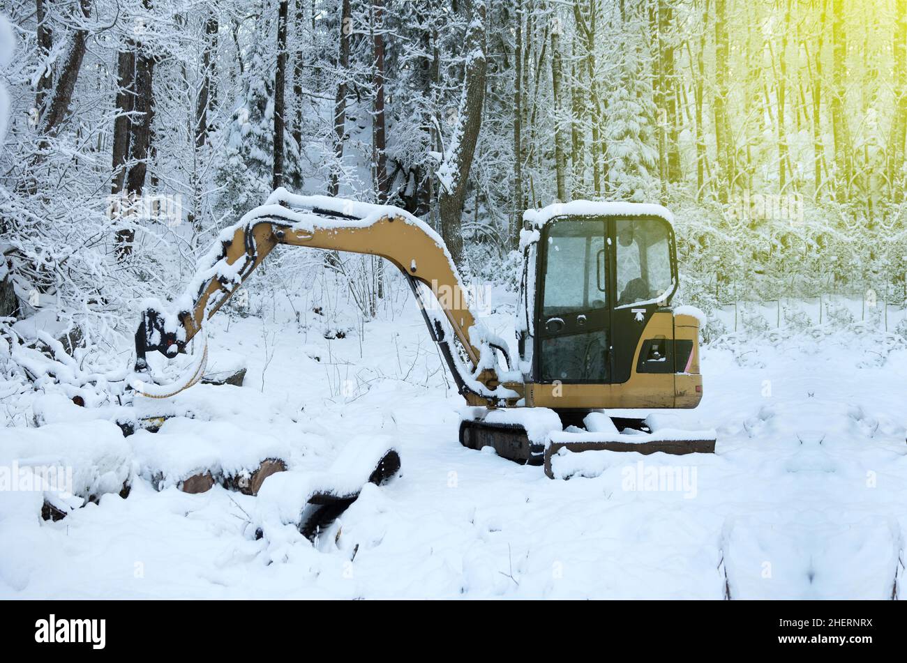 Excavator removing snow from the road in winter Stock Photo