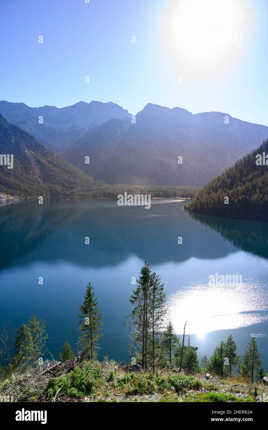 lake plansee at fall in austrian alps with sun and reflections Stock ...