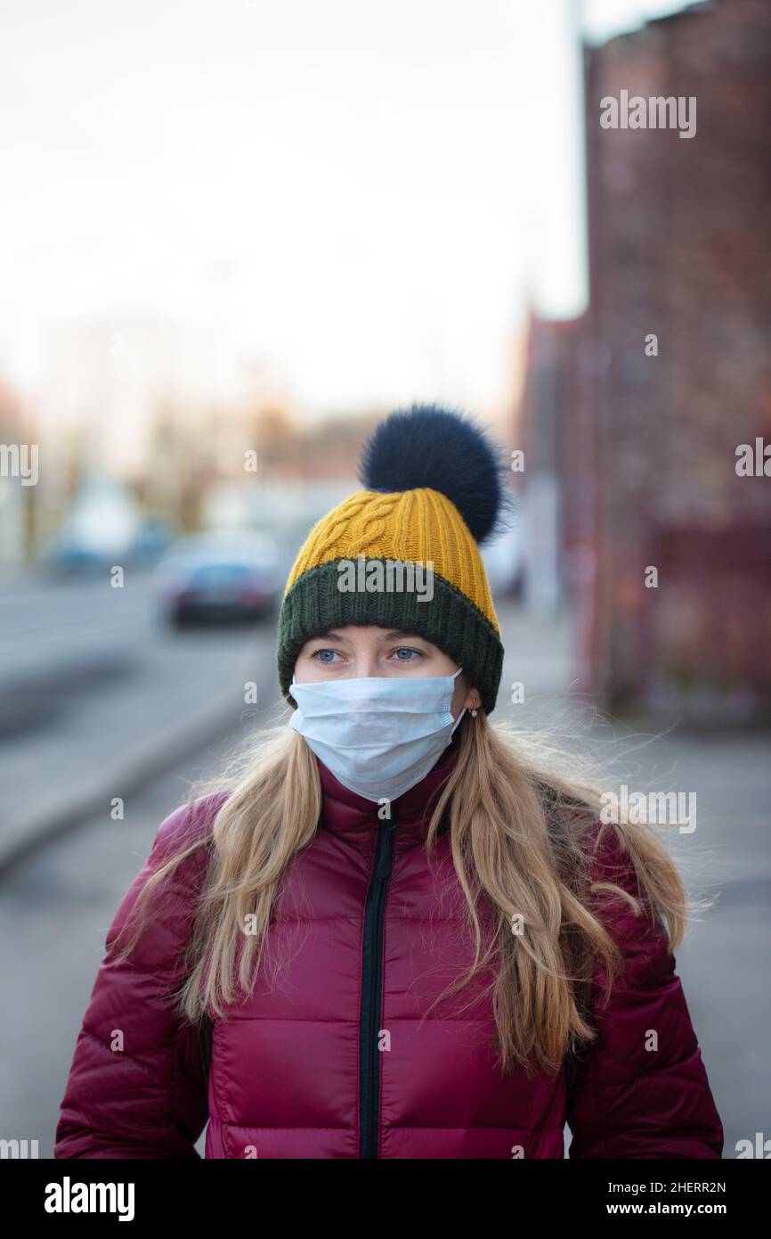 Woman wearing face mask to protect herself from virus. Coronavirus outbreak of flu epidemic concept Stock Photo