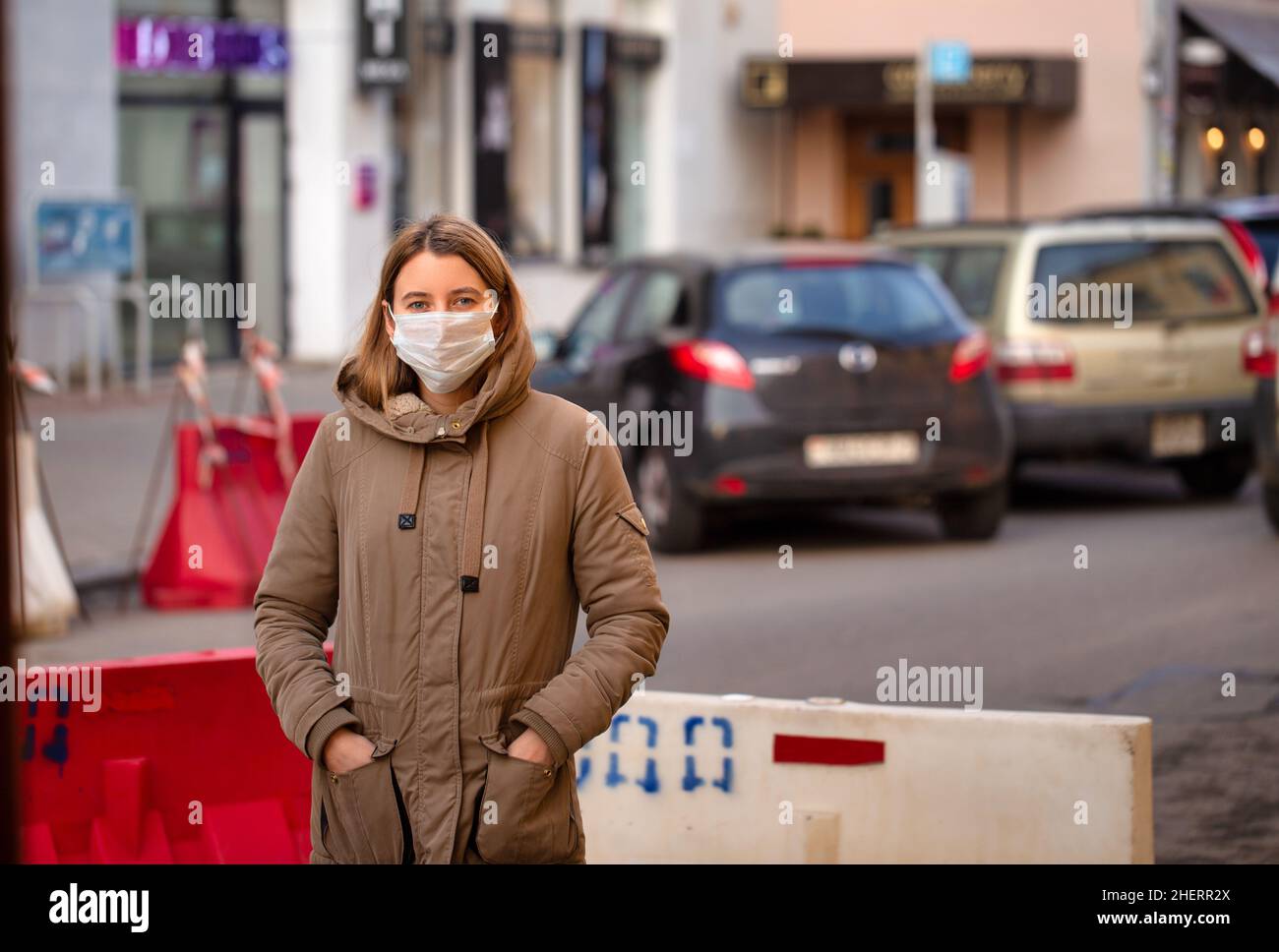 Woman wearing a surgical mask on Italy street. Young female in face mask to prevent coronavirus flu spread Stock Photo
