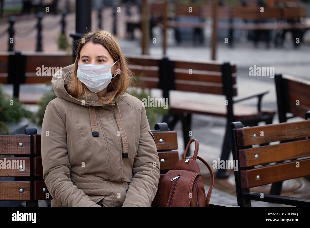 Young woman wearing face mask during flu virus outbreak. Coronavirus epidemic lockdown. Stock Photo