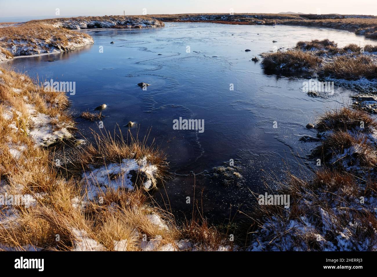 A frozen tarn on the Langdale Pikes in the English Lake  District. Stock Photo