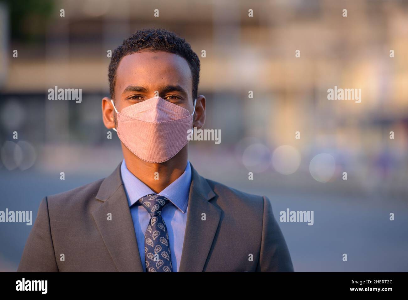 African businessman wearing face mask to protect himself from covid 19 as new normal Stock Photo