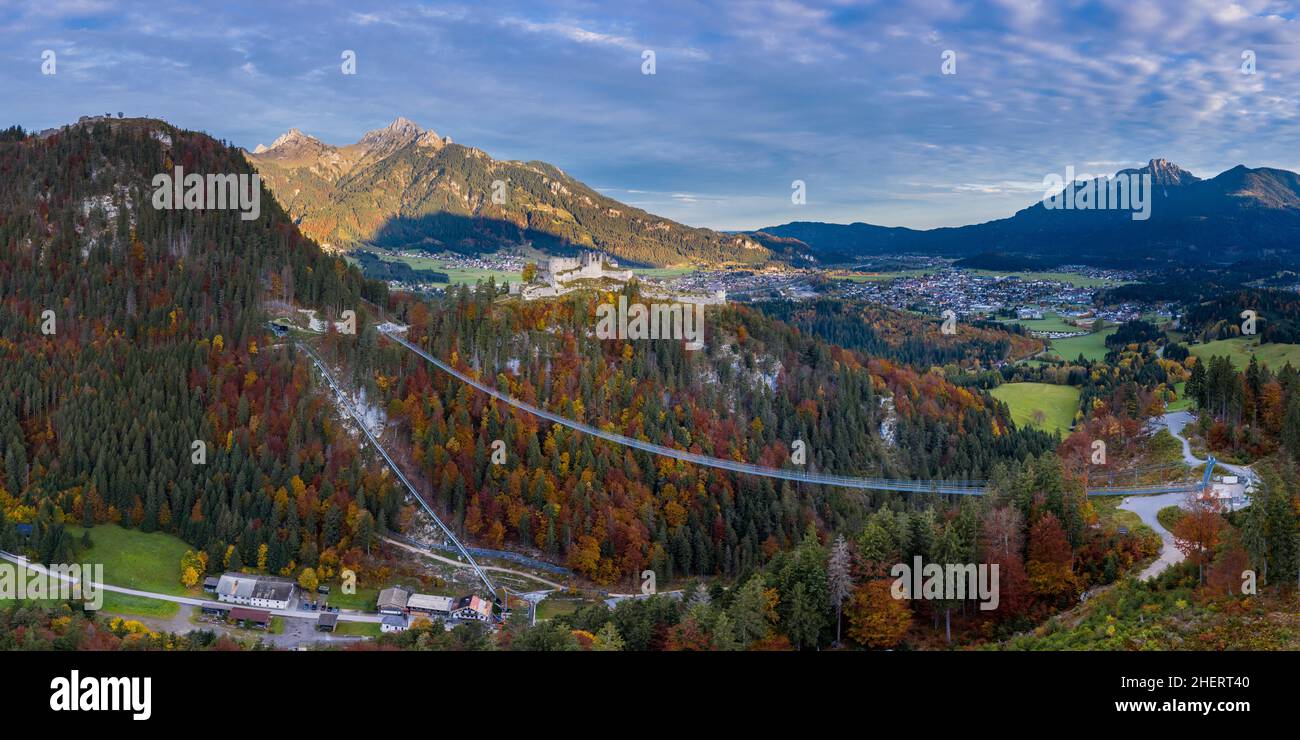 rope bridge to ruin castle ehrenberg with view to village reutte at fall Stock Photo