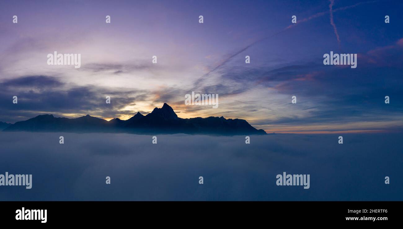 over cloud carpet with hahnenkamm mountains at misty sunset at reutte Stock Photo