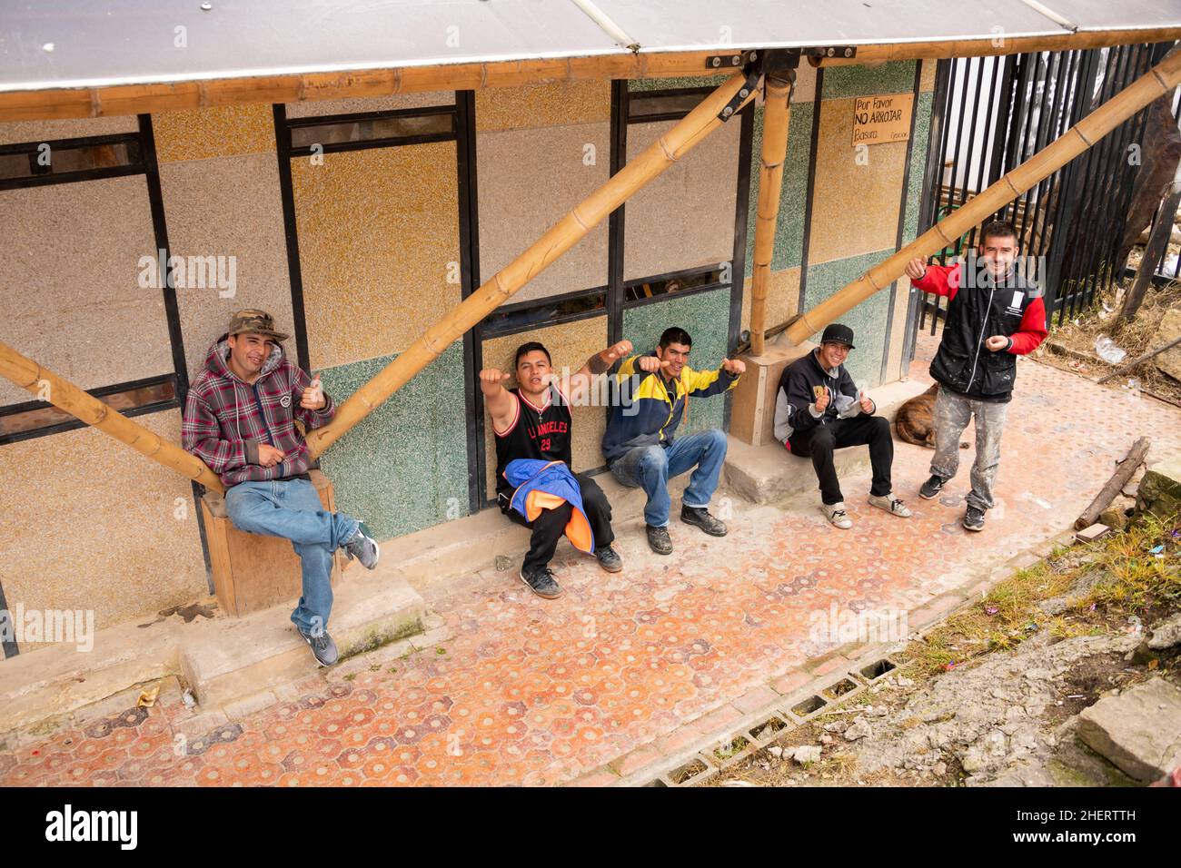 Group of men outside a shack house, in the once notorious gang Barrio Egipto neighbourhood, Bogota, Colombia, South America. Stock Photo