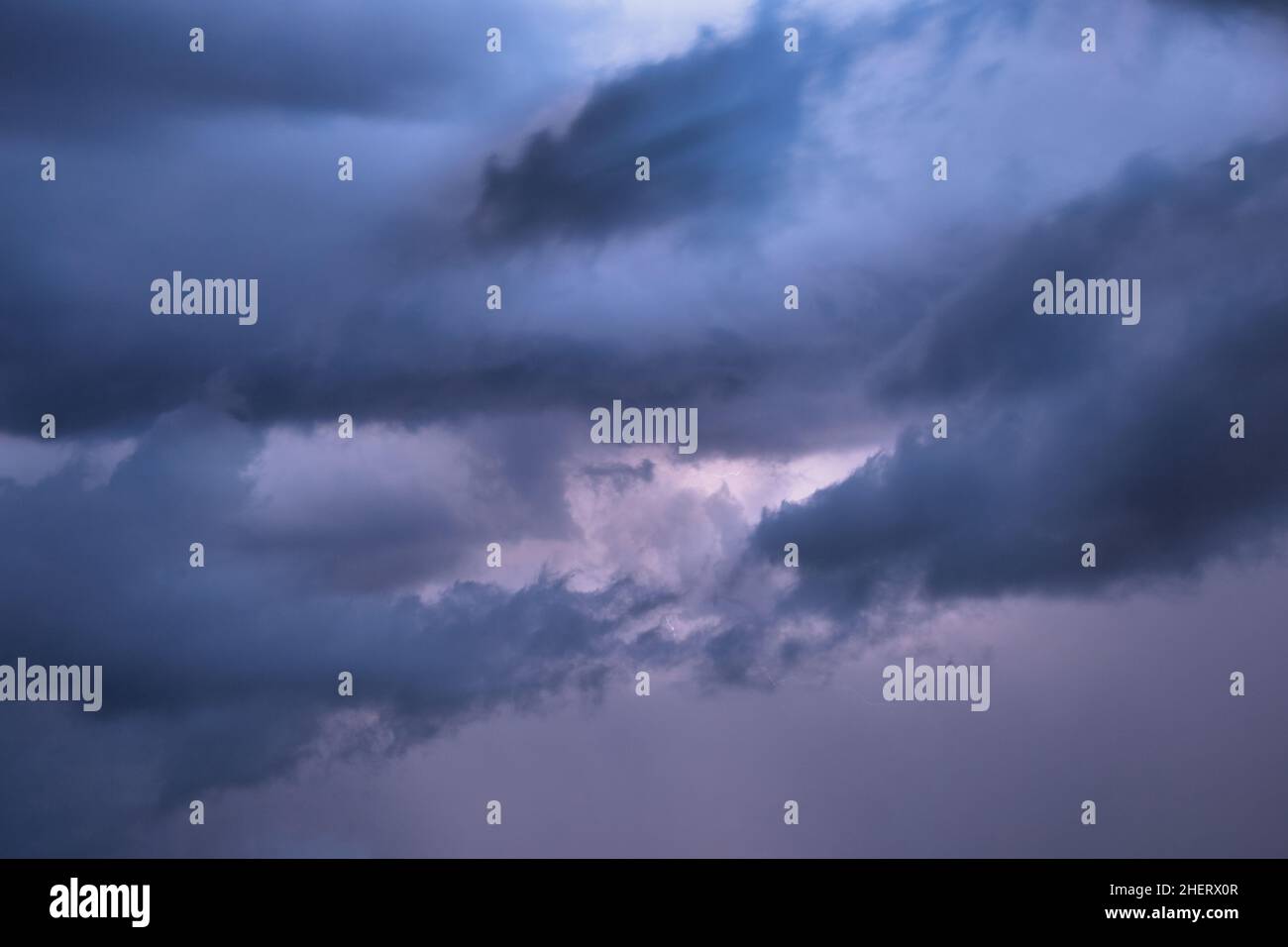 Light in the dark dramatic storm clouds background Stock Photo