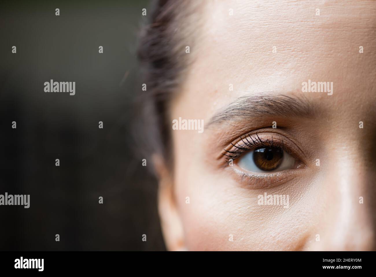 partial view of young woman looking at camera, eye care concept Stock Photo