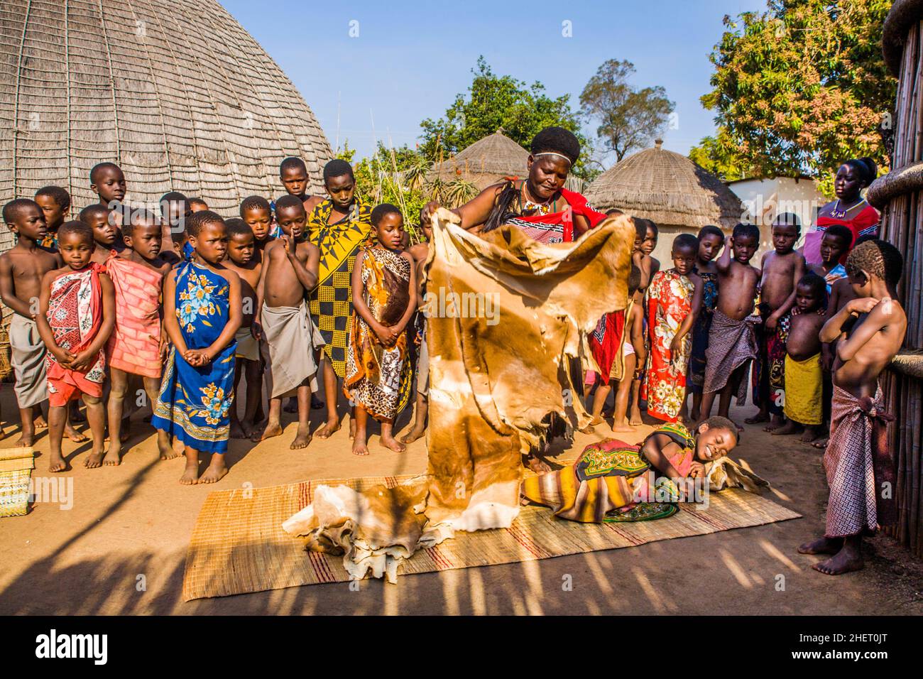 Children watch with interest at traditional customs in real African village, Umphakatsi Chief Stock Photo