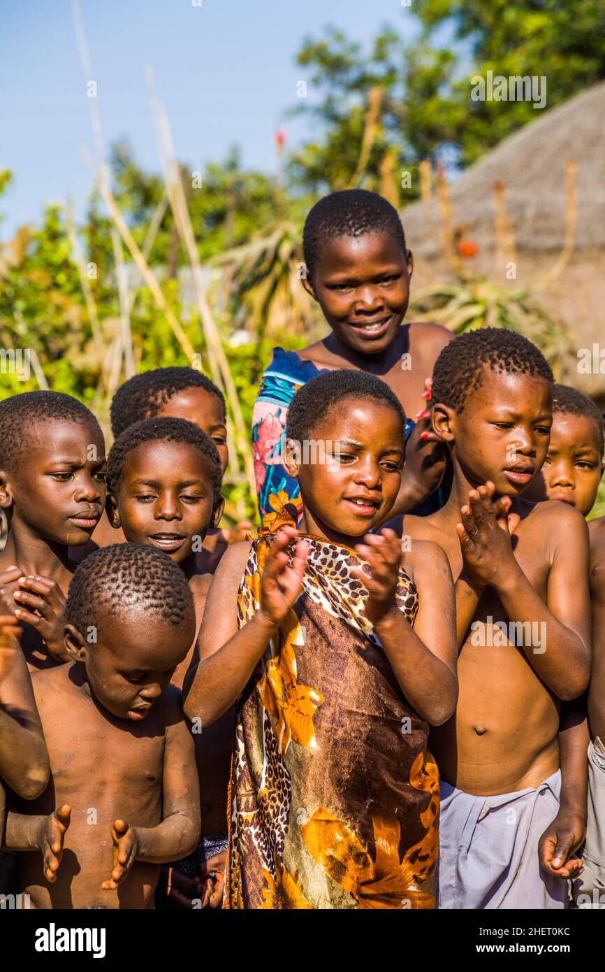 Children watch with interest at traditional customs in real African village, Umphakatsi Chief Stock Photo