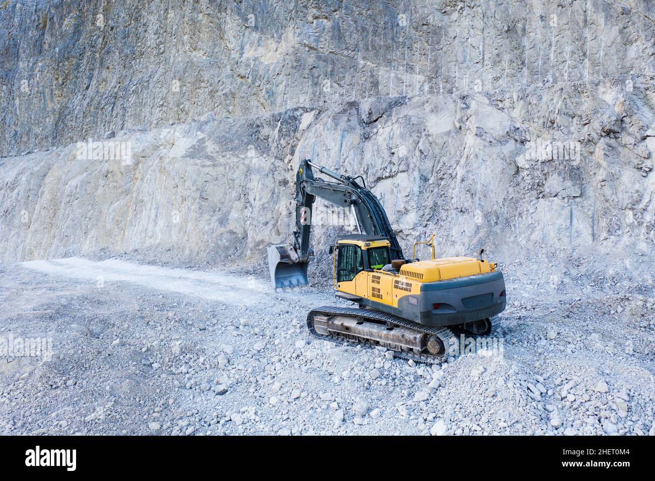 huge heavy excavation digger with shovel at limestone stone quarry