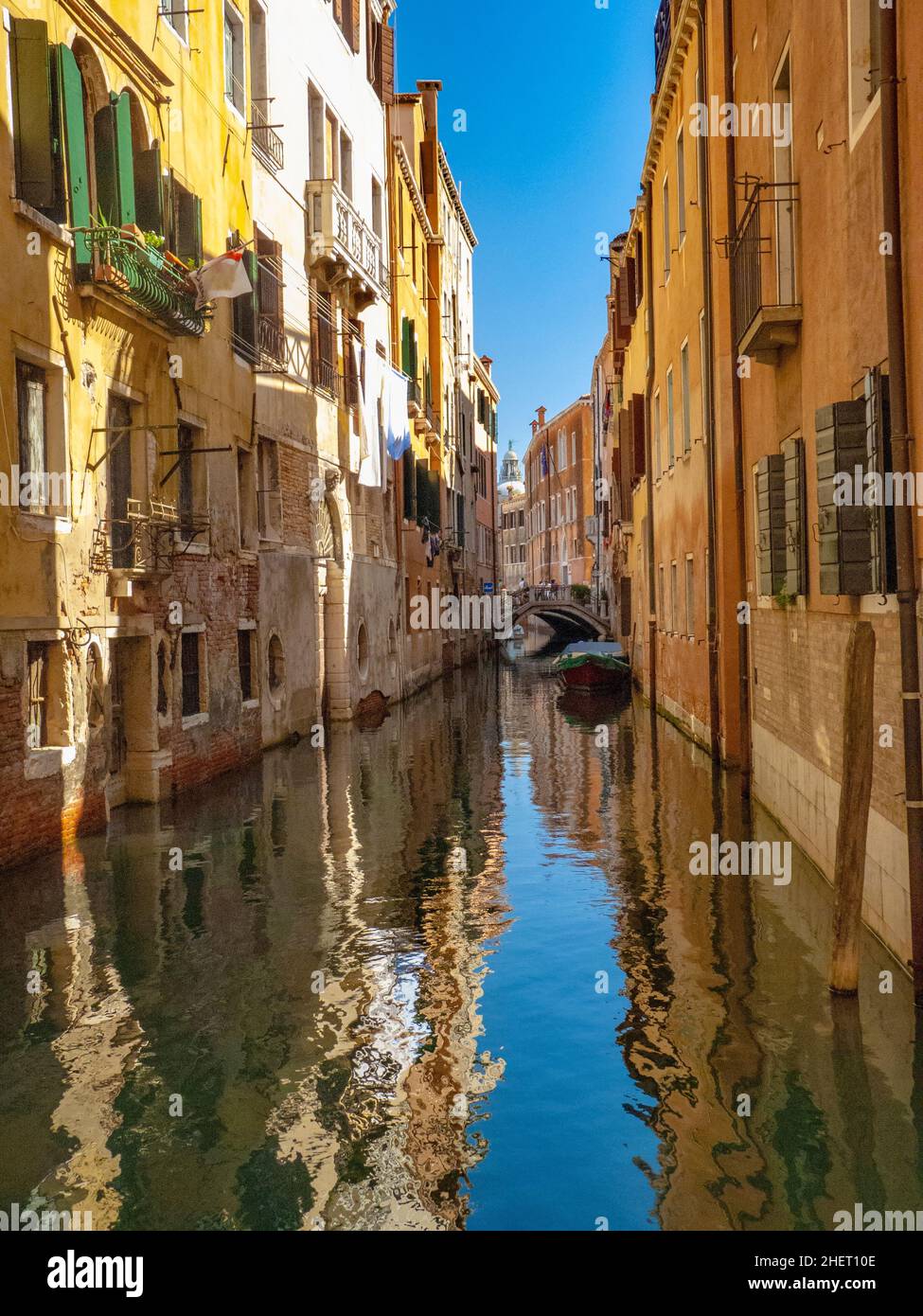 colorful small canal in the city of venice with narrow houses Stock ...