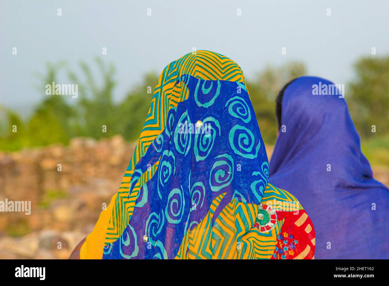 women wear the colorful headscarfs with traditional pattern in the heat of india but without covering the face Stock Photo