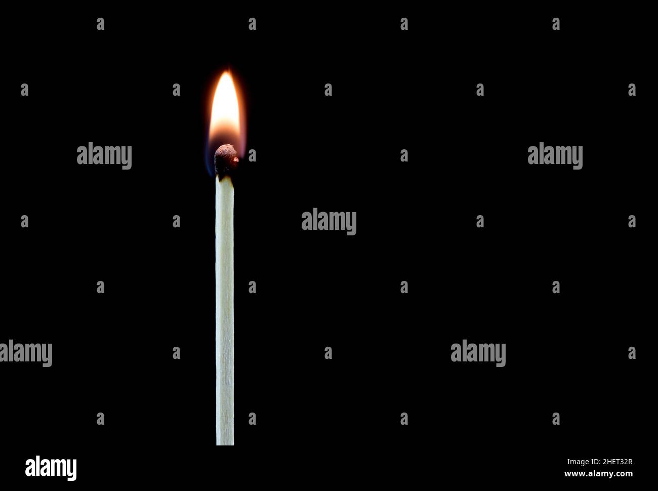 Upright burning match isolated on a black background Stock Photo