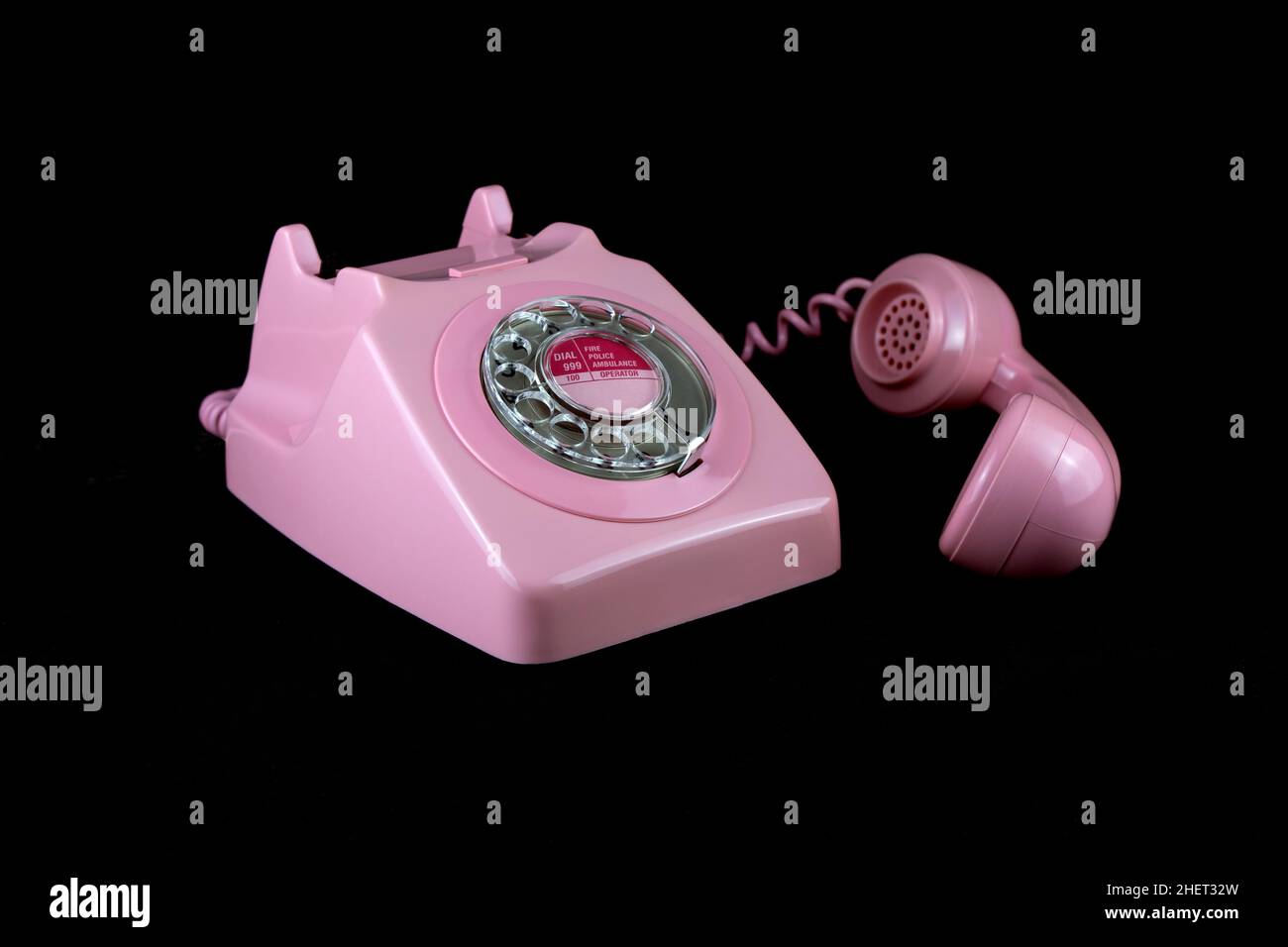 Vintage pink telephone isolated on a black background Stock Photo - Alamy