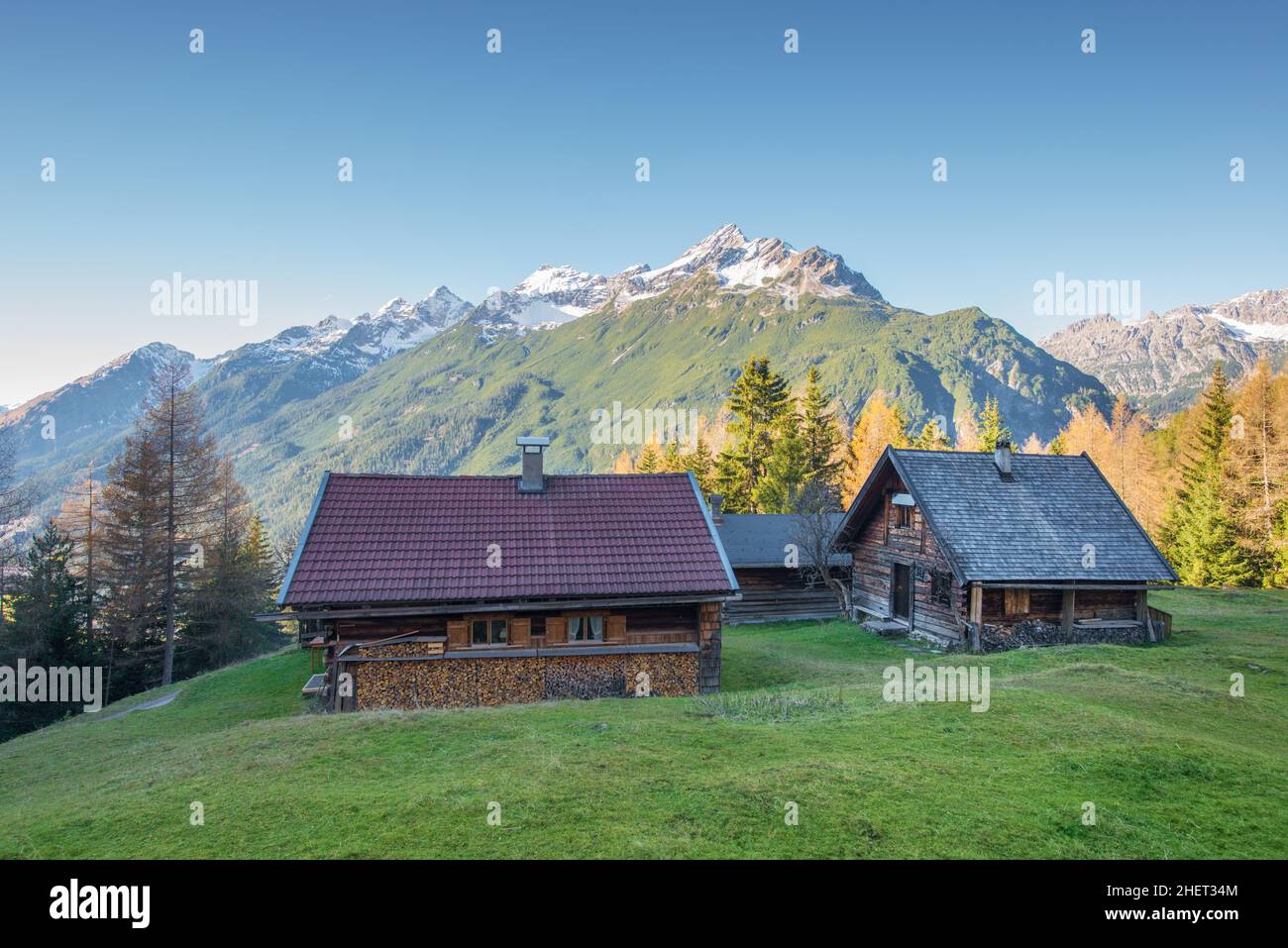 Gallery Detail: Wooden Chalets On Mountain Meadow At Austrian Alps Stock Photo