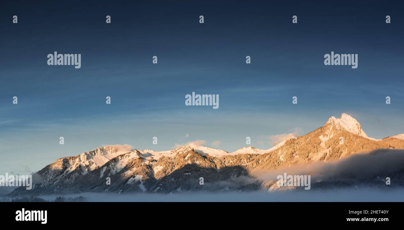 panorama of mountain chain hahnenkamm in winter at sunrise Stock Photo