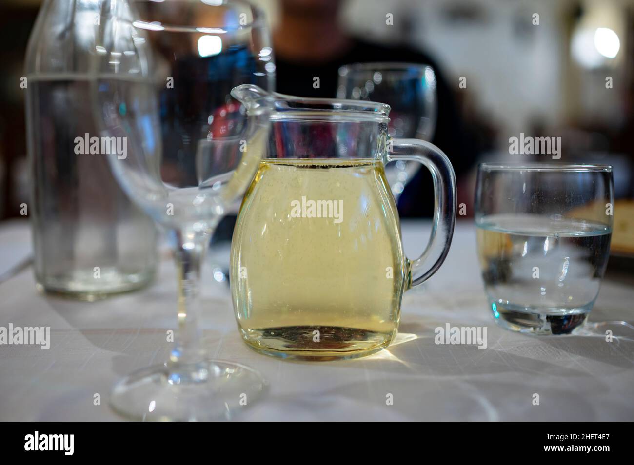 Italian white house wine served in pitcher with two glasses