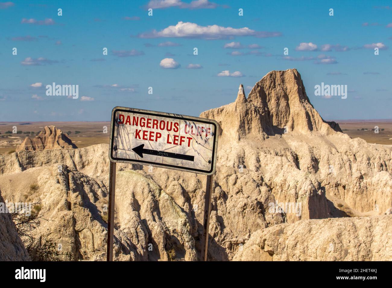 Danger Ahead Keep Left sign on a cliff in the Badlands in South Dakota, USA Stock Photo
