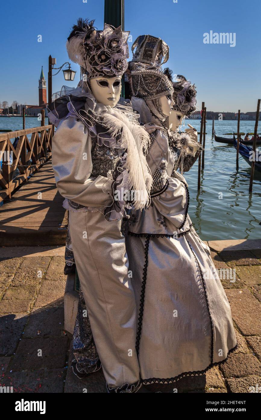 People in beautiful fancy dress historic costume and mask by the lagoon at  Venice Carnival, Carnevale di Venezia, Veneto, Italy Stock Photo - Alamy