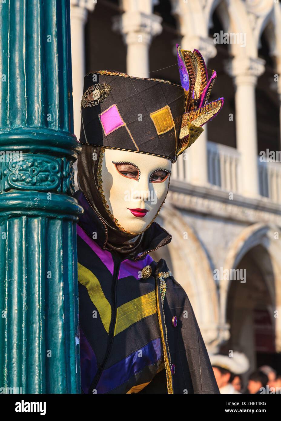 Woman in historic Venetian fancy dress costume, hat and mask, poses at Venice Carnival, Carnevale di Venezia, Italy Stock Photo