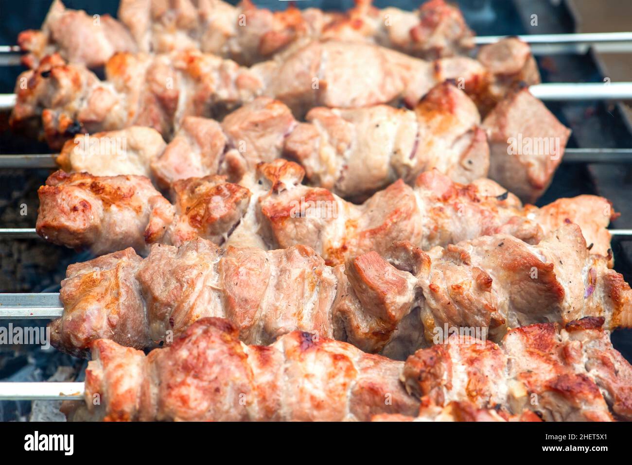 Cooking barbecue, grilled meat barbecue. Cooking pork shashlik on metal skewers. Smoke from