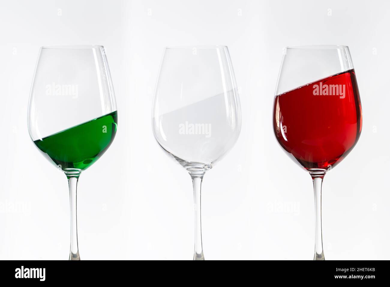 three wine glasses filled with the colors of the italy flag Stock Photo