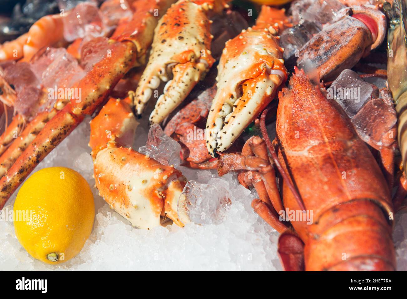 fresh frozen lobster on ice with lemon at market Stock Photo Alamy