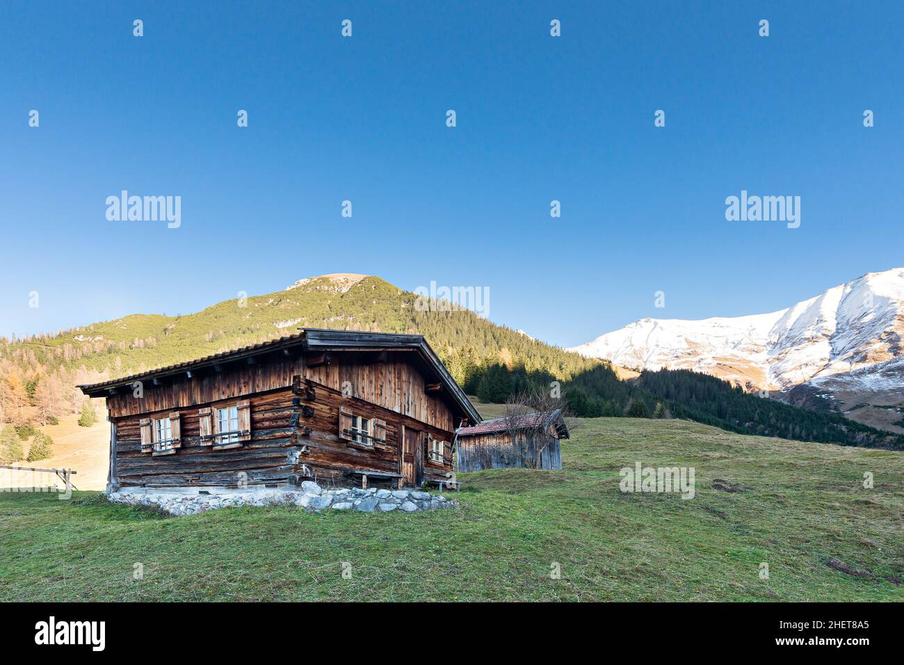 sun burned timber chalet hut on austrian mountains at fall Stock Photo