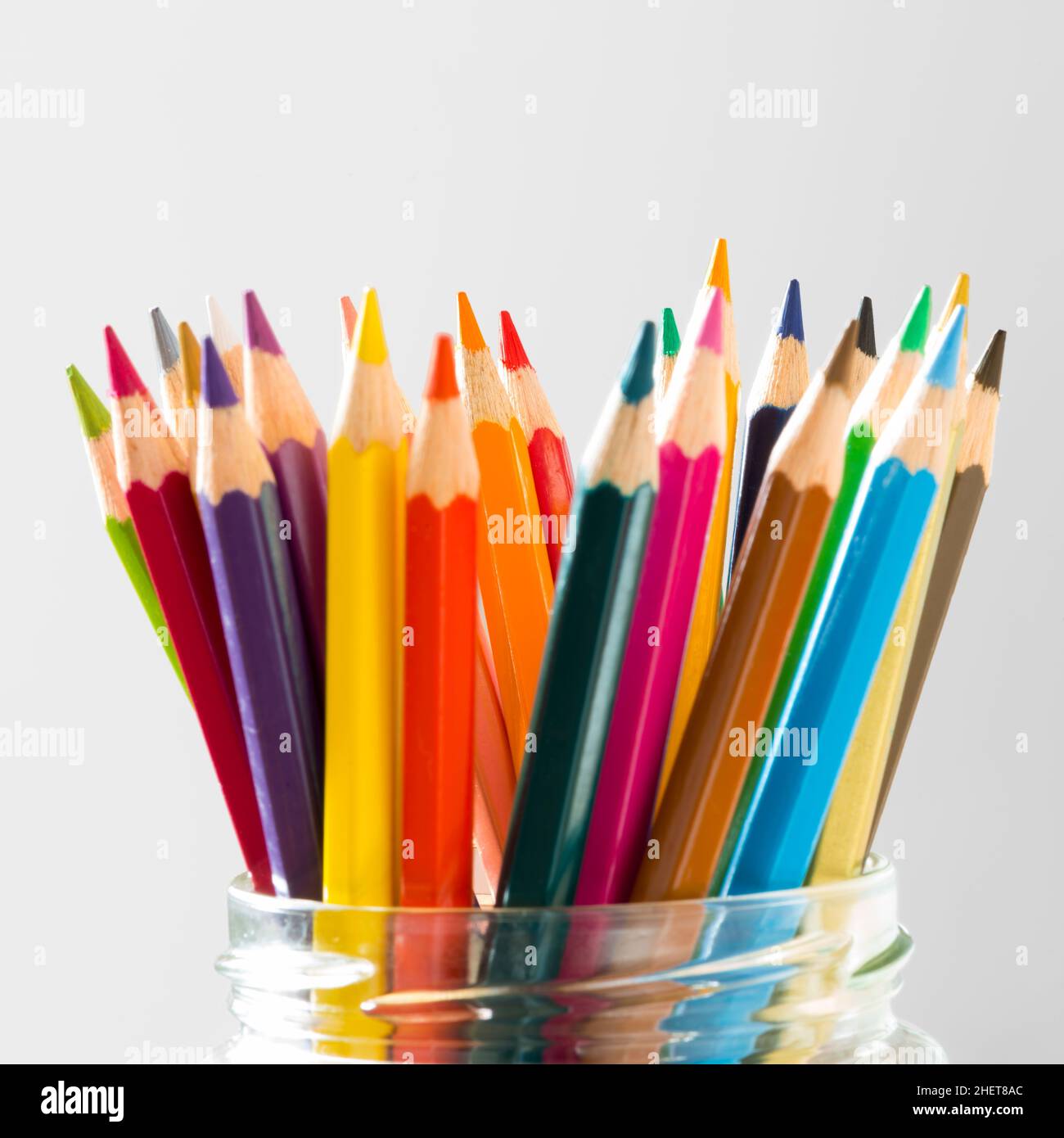 many color wood pencils standing in glass on white Stock Photo Alamy