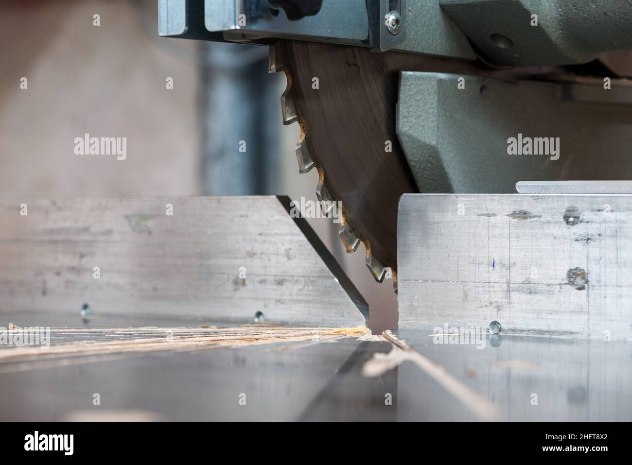 detail of fixed  circular buzz miter saw blade and table Stock Photo