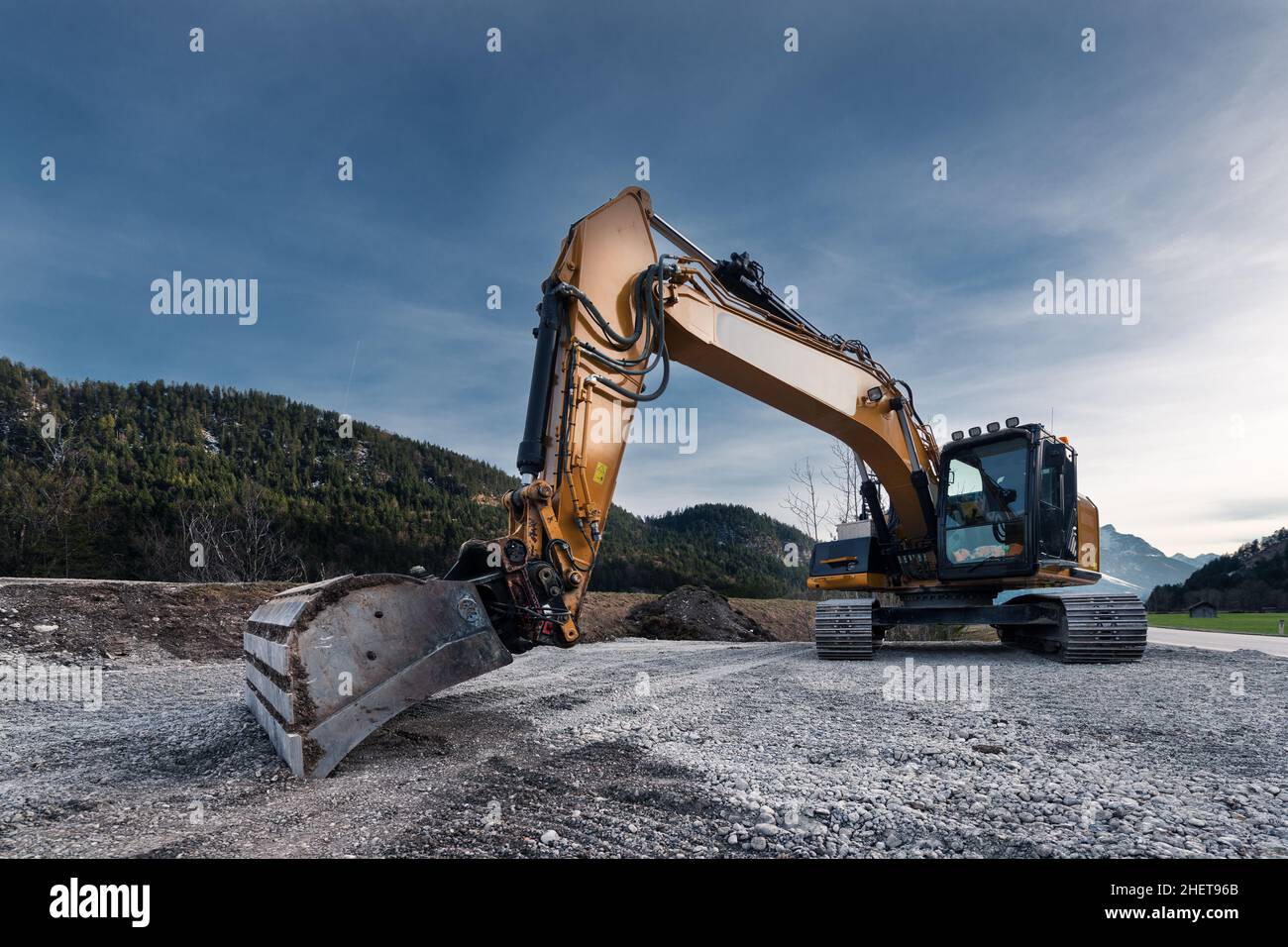 view to huge orange mechanical shovel excavator on gravel Stock Photo