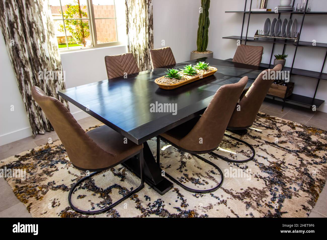 Oblong Wooden Table With Six High Bach Chairs In Dining Room Stock