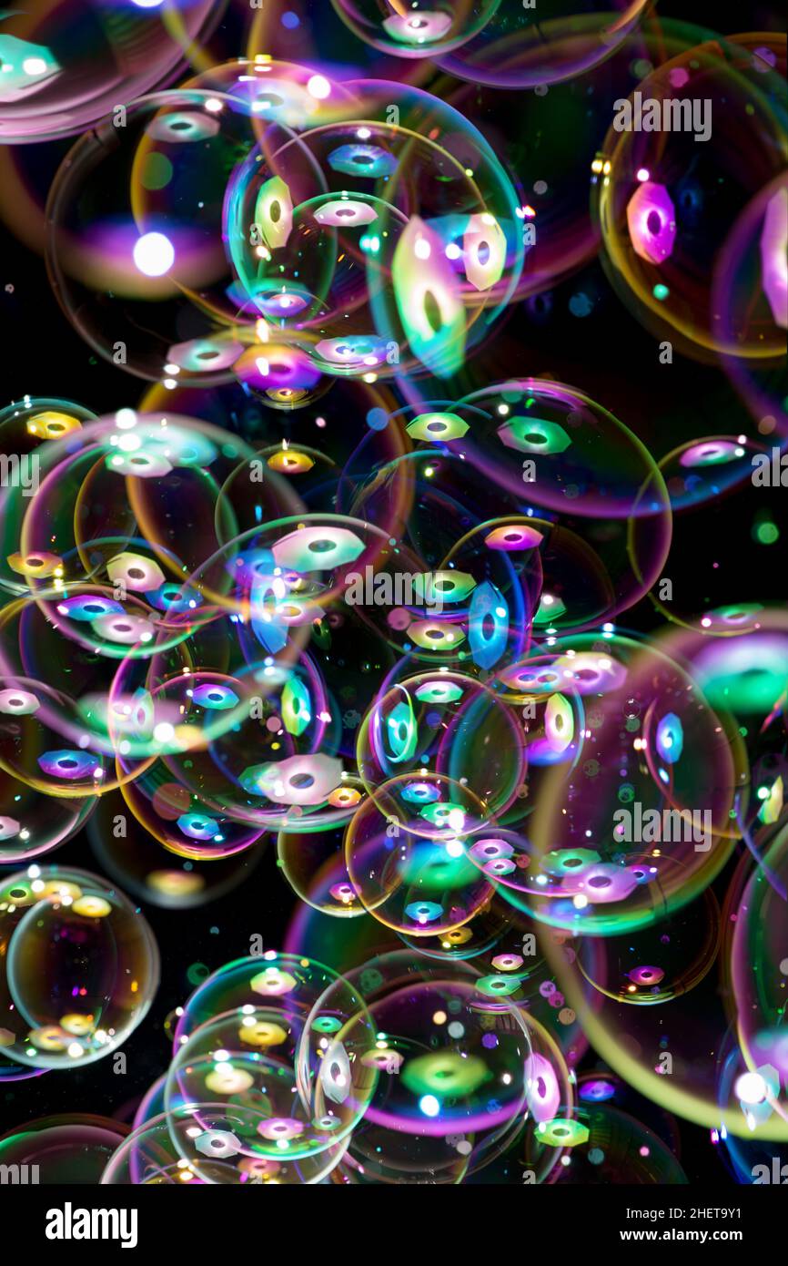 many soap bubbles flying on black background Stock Photo - Alamy