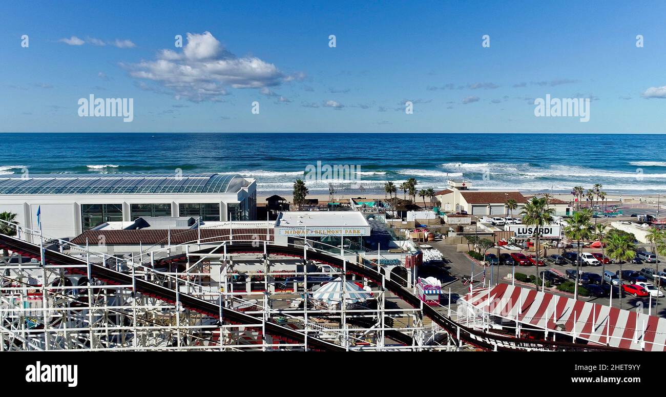 Aerial view Mission Beach, with wooden Giant Dipper roller coaster and amusement rides, historic Belmont Park at sunrise, San Diego, California, USA Stock Photo