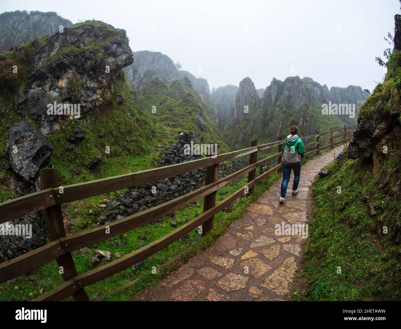 A young tourist walking along a path in the lakes of Covadonga in the Picos de Europa National Park in Asturias. Stock Photo