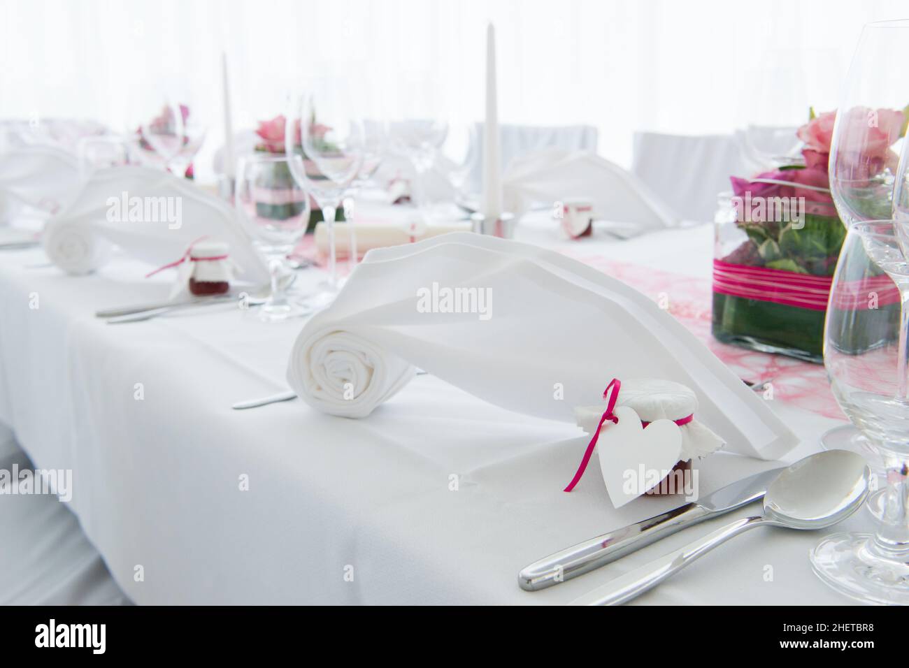 white nuptial decorated wedding table with napkin and flowers Stock Photo