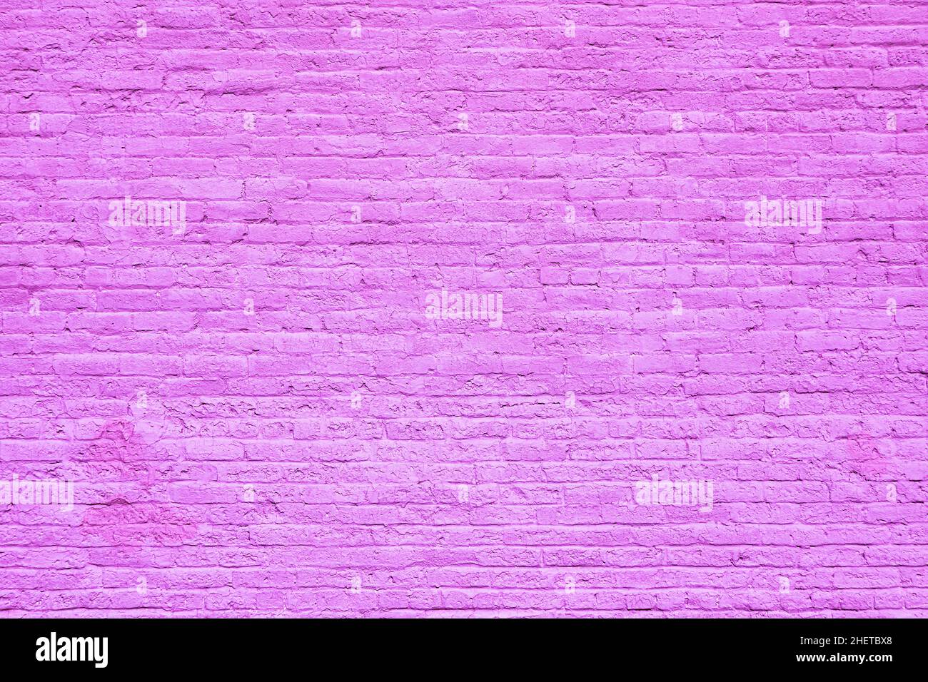 harmonic old brick wall painted in violet as background Stock Photo