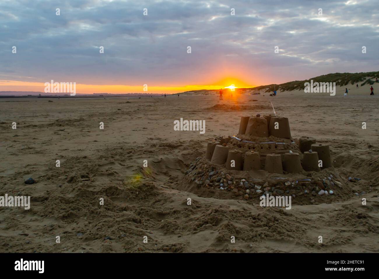Large sandcastle on Camber Sands beach at sunset in England Stock Photo