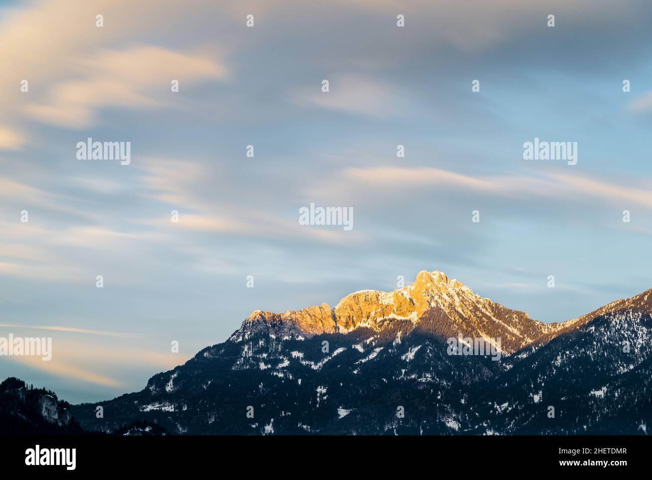 afterglow on austrian mountains with motion clouds in winter Stock Photo