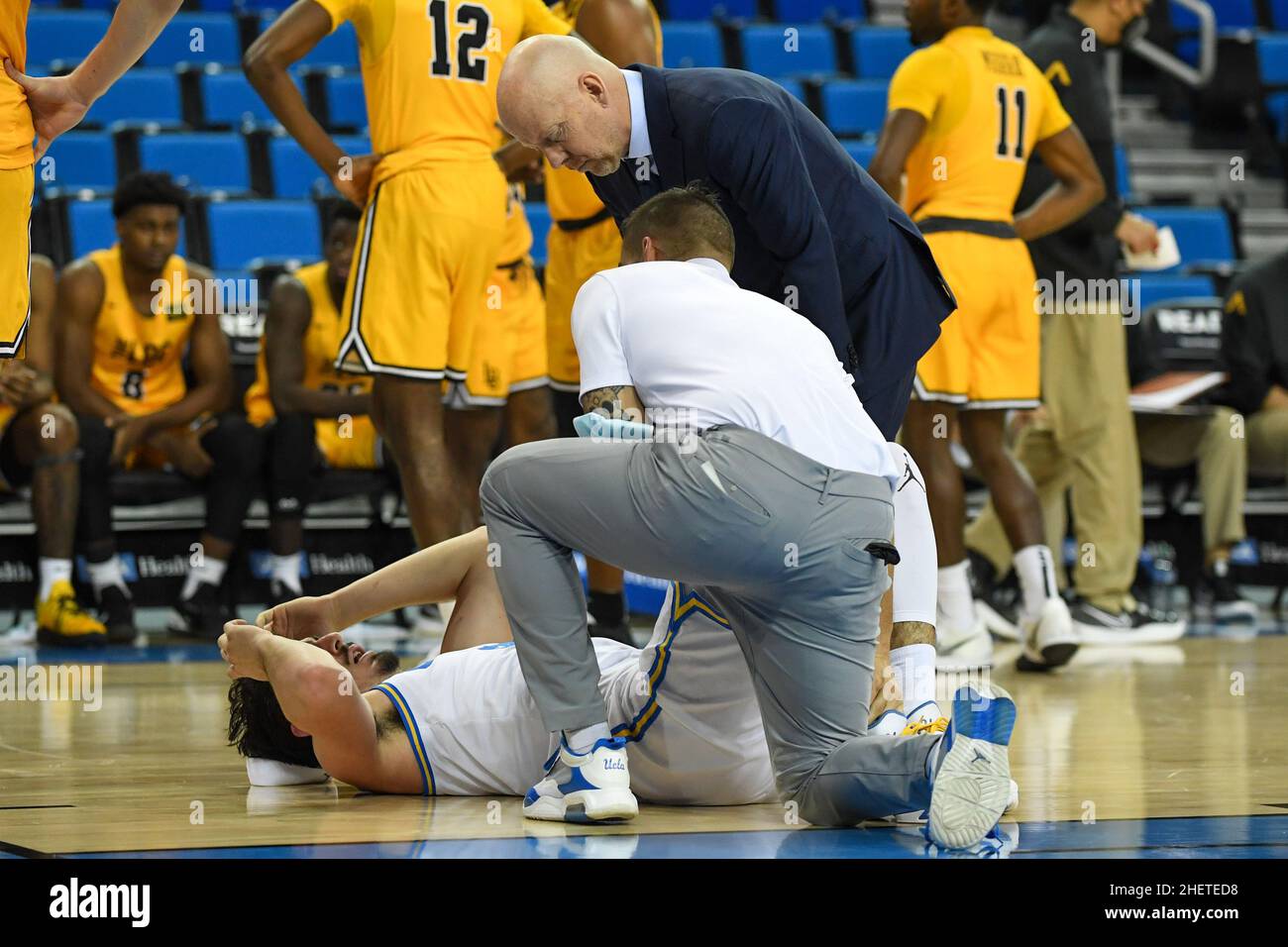 UCLA Bruins guard Jaime Jaquez Jr. (24) holds his ankle during an NCAA basketball game against the Long Beach State 49ers, Thursday, Jan. 6, 2022, in Stock Photo