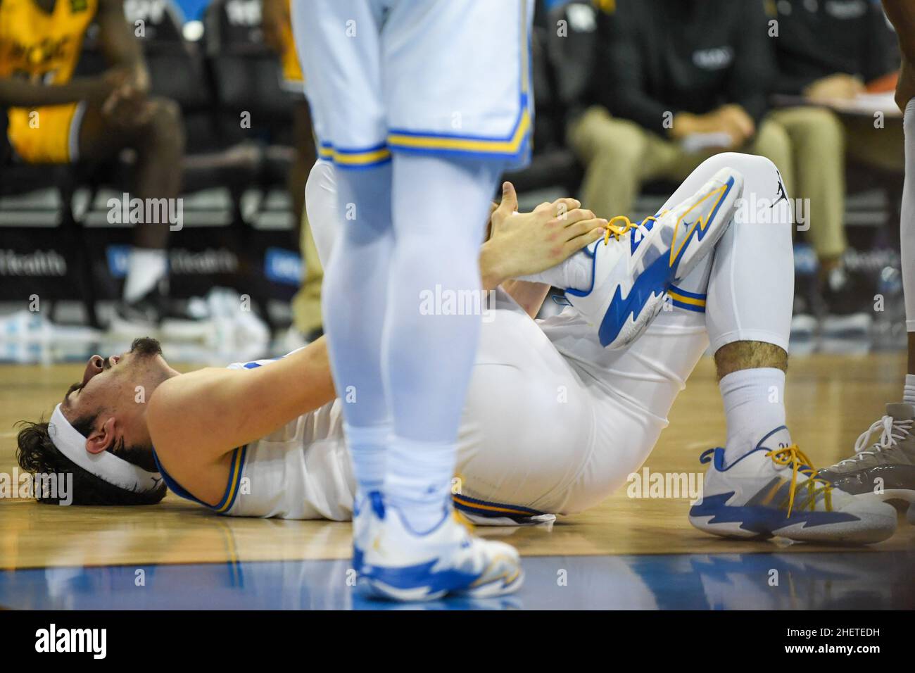 UCLA Bruins guard Jaime Jaquez Jr. (24) holds his ankle during an NCAA basketball game against the Long Beach State 49ers, Thursday, Jan. 6, 2022, in Stock Photo