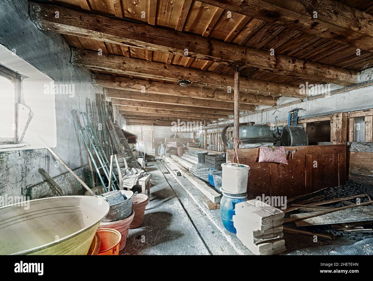 old barn storage room with light beams through window Stock Photo